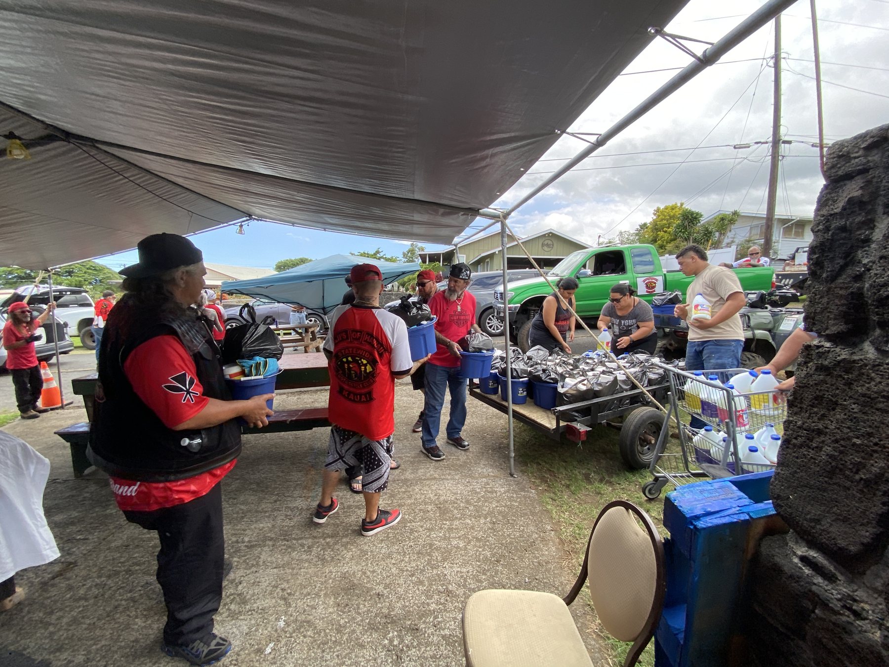 Volunteers and club members gather around donated supplies