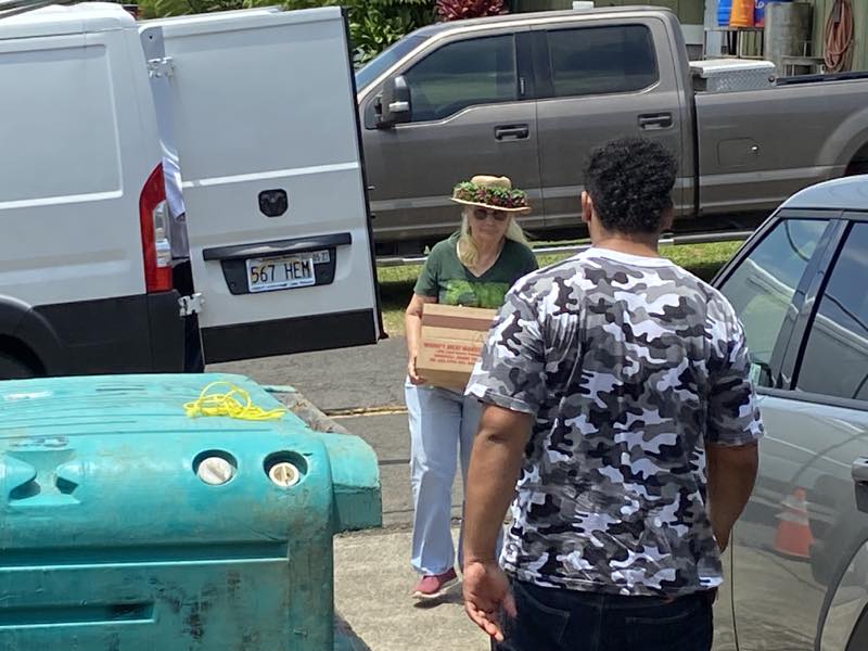 A community member receives a box of supplies