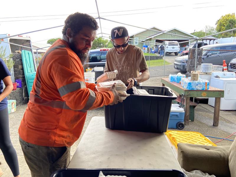 Volunteers organize meal containers