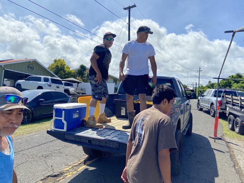 Volunteers unload supplies from a pickup