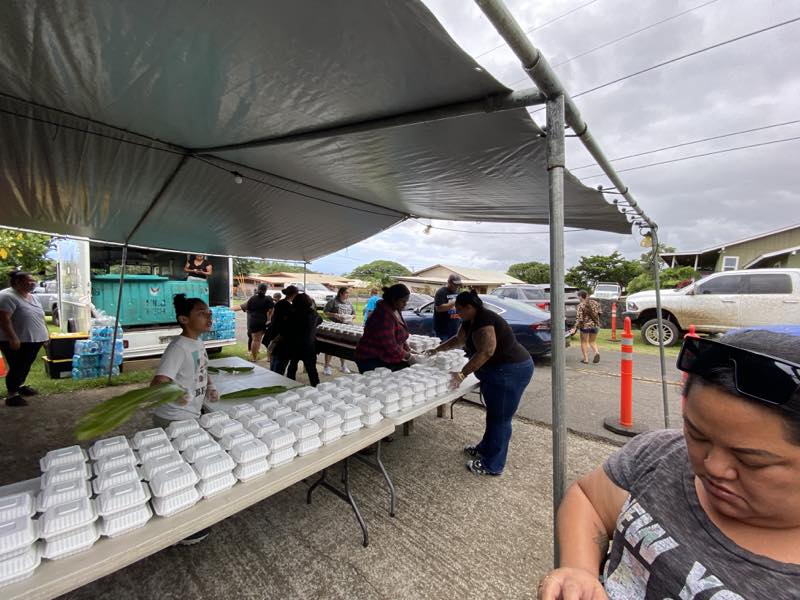 Volunteers prepare and pack meals