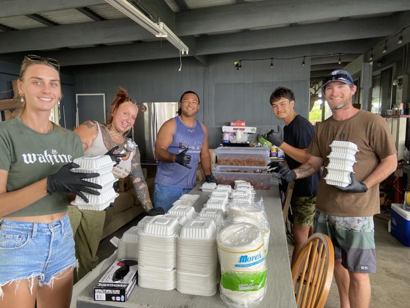 Volunteers prepare meals for distribution