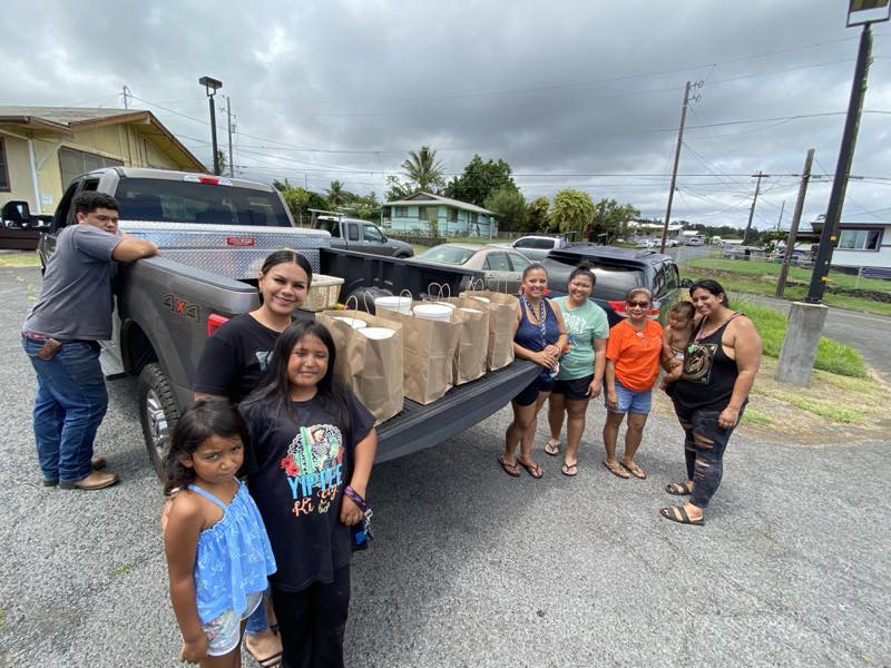 Community members collect prepared meals