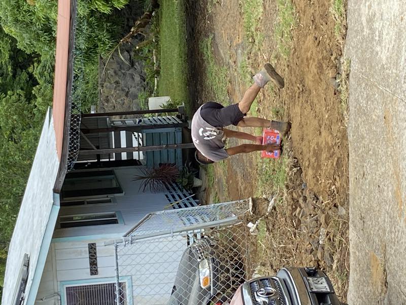 A volunteer carries supplies to a family