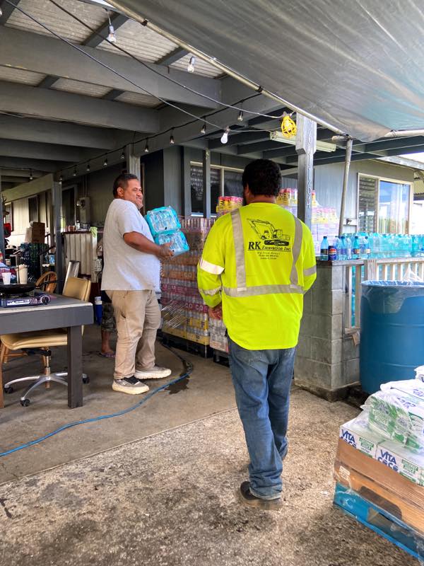 Volunteers carry donated water to the hub