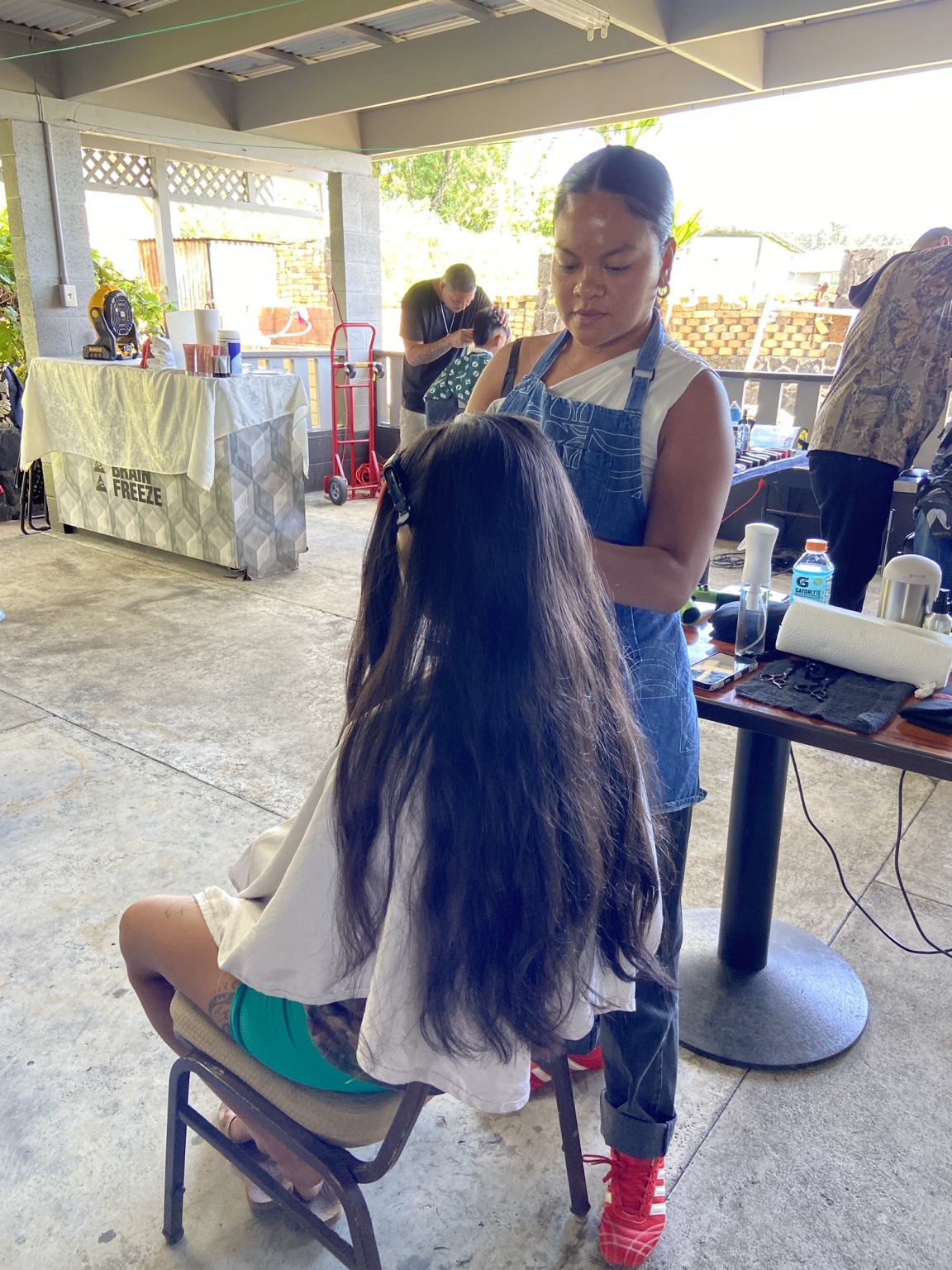 Having a haircut at the Kaumahana Hub
