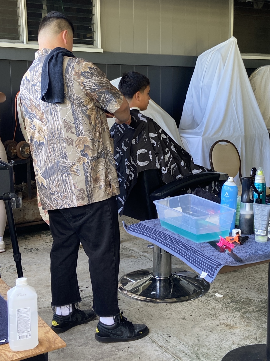 A community haircut at the Kaumahana Hub